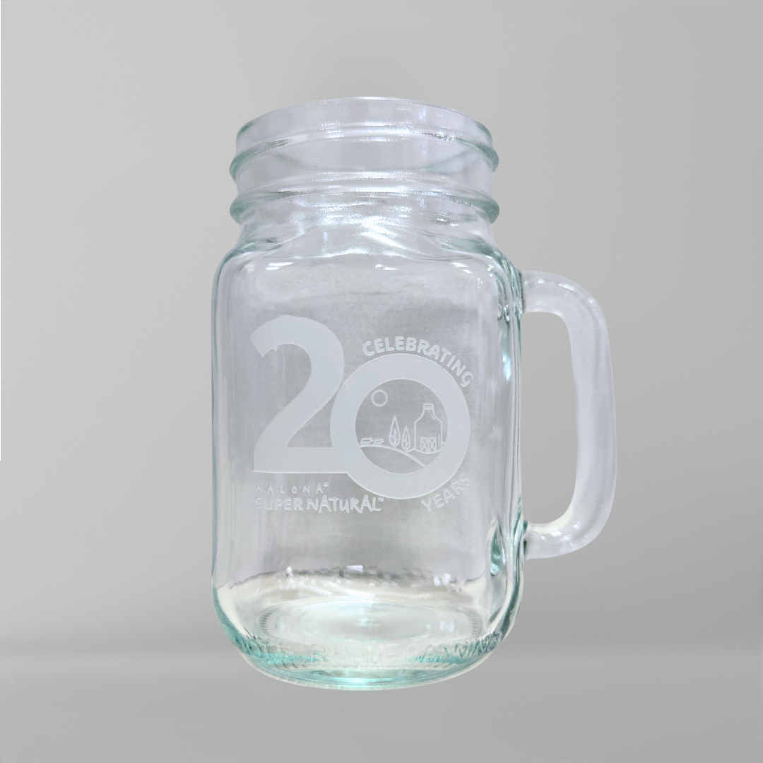 A glass mug with 'Celebrating 20 Years' and the Kalona SuperNatural logo etched on the front.