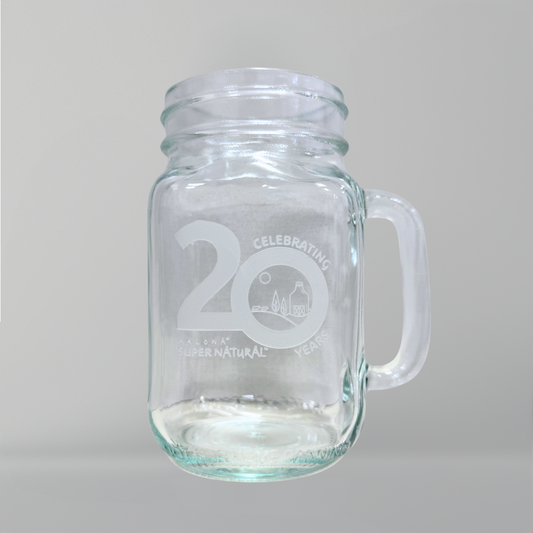 A glass mug with 'Celebrating 20 Years' and the Kalona SuperNatural logo etched on the front.